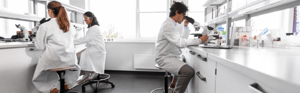 white coated professionals conducting equipment validation in a laboratory white coated professionals conducting equipment validation in a laboratory